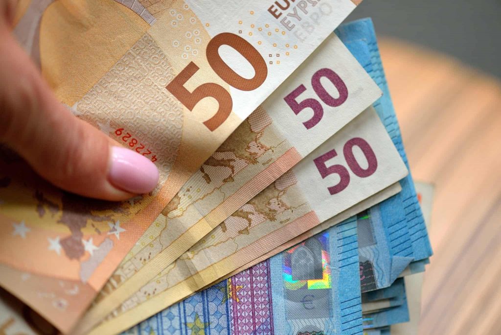 hand holding 50 and 20 euro banknotes money eur currency of european union t20 GJxWK0